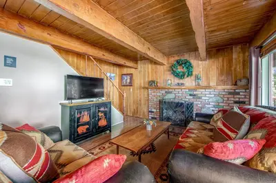 a living room with a couch and a fireplace at Adorable Explorable in Lake Arrowhead