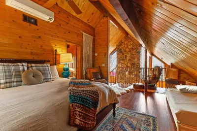 a bedroom with a bed in a wooden cabin at Howard's Cabin in Lake Arrowhead