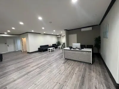 a large room with a couch and a table at ASPIRE INN & SUITES Orange in Orange