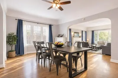 a dining room and living room with a table and chairs at Modern LA Home Near Museums, Dining & Downtown in Los Angeles