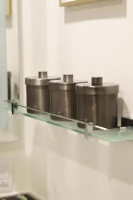a row of pots on a glass shelf in a kitchen at Classic Los Angeles Elegance in Downtown, Sleeps 4, Free Parking and 360 Degree View Roof Top Pool! in Los Angeles