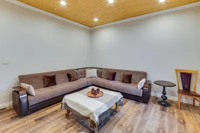 a living room with a couch and a table at Cozy Pine Mountain Club Cabin with Large Deck in Pine Mountain Club