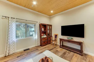 a living room with a flat screen tv on the wall at Cozy Pine Mountain Club Cabin with Large Deck in Pine Mountain Club