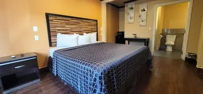a hotel room with a bed and a bathroom at RUBY MOTEL in Long Beach
