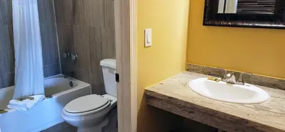 a bathroom with a white toilet and a sink at RUBY MOTEL in Long Beach