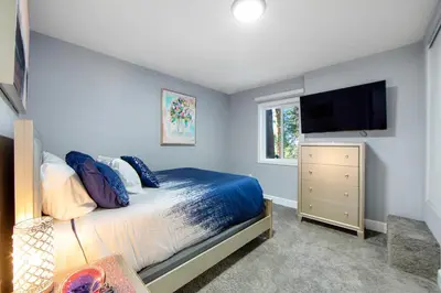 a bedroom with a bed and a flat screen tv at Arrowhead Aerie in Lake Arrowhead