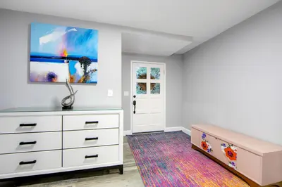 a bedroom with a dresser and a painting on the wall at Arrowhead Aerie in Lake Arrowhead