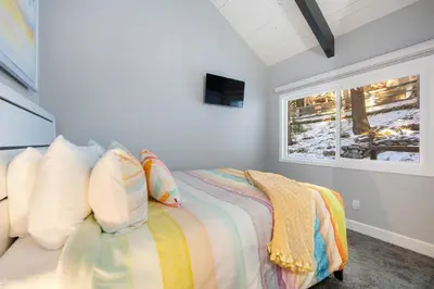 a bedroom with a bed and a window at Arrowhead Aerie in Lake Arrowhead