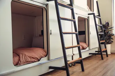 a room with three bunk beds and two mirrors at STAY OPEN Venice Beach in Los Angeles