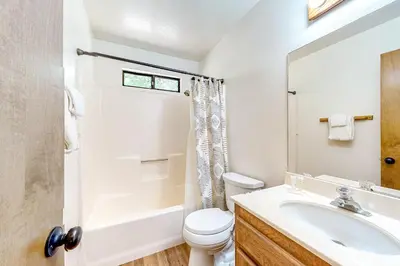 a white bathroom with a sink and a toilet at Grey Stone Fire in Running Springs