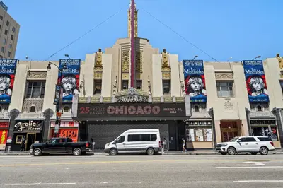 a city street with cars parked in front of a theater at Hollywood Le Bon Hotel in Los Angeles