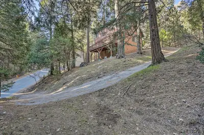 a house on a hill with a road at Cozy Cabin about 3 Mi to Lake Arrowhead Village! in Lake Arrowhead