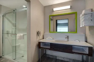 a bathroom with a sink and a glass shower at Hampton Inn & Suites By Hilton Rancho Cucamonga in Rancho Cucamonga