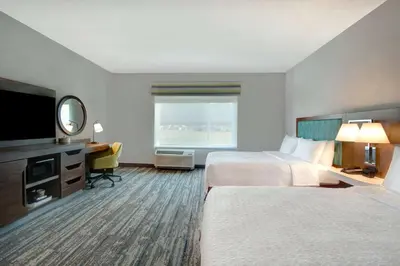a hotel room with two beds and a flat screen tv at Hampton Inn & Suites By Hilton Rancho Cucamonga in Rancho Cucamonga