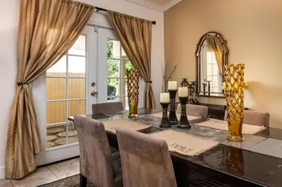 a dining room with a table and chairs and a window at Villa Sausalito - Newly Designed 4BR HOUSE & POOL by Topanga in Los Angeles