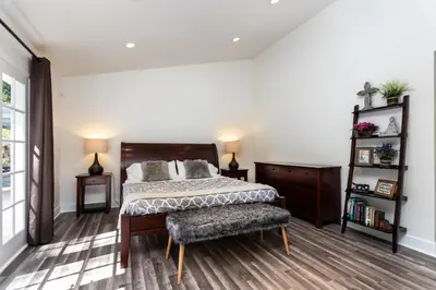 a bedroom with a bed and a chair at Villa Sausalito - Newly Designed 4BR HOUSE & POOL by Topanga in Los Angeles