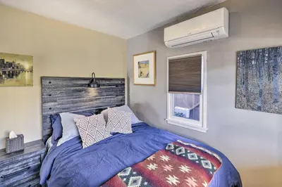 a bedroom with a bed and a air conditioner at Charming Craftsman Bungalow with Garden and Hot Tub! in Fullerton