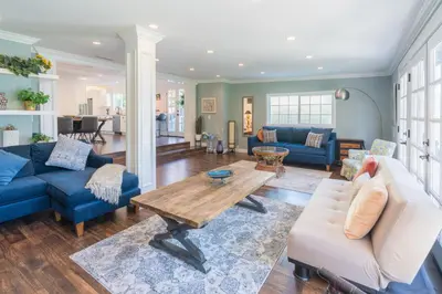 a living room with blue couches and a wooden table at Le Bleu House - Newly Designed 3BR HOUSE & POOL by Topanga in Los Angeles