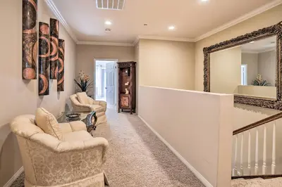 a living room with two chairs and a mirror at Huge Lake Arrowhead Home with 3 Decks and Grill! in Lake Arrowhead