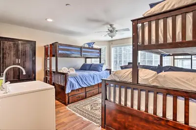 a bedroom with a bunk bed and a sink at Huge Lake Arrowhead Home with 3 Decks and Grill! in Lake Arrowhead