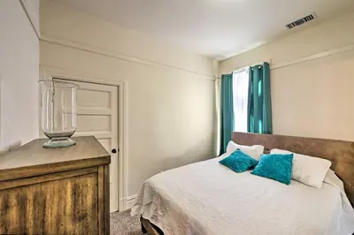 a bedroom with a bed and a glass vase on a dresser at Riverside House with Yard about 1 Mi to Downtown! in Riverside