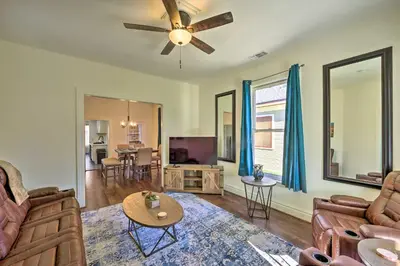 a living room with a couch and a ceiling fan at Riverside House with Yard about 1 Mi to Downtown! in Riverside