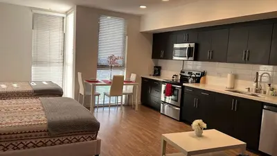 a room with a bed and a kitchen with a table at Incredible Hollywood Loft Free Parking in Los Angeles