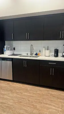a kitchen with black cabinets and a sink at Exceptional Loft FREE Parking and WIFI in Los Angeles