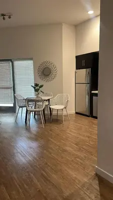 a kitchen with a table and chairs and a refrigerator at Exceptional Loft FREE Parking and WIFI in Los Angeles