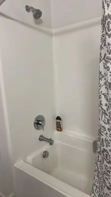 a white bath tub with a shower curtain and a sink at Exceptional Loft FREE Parking and WIFI in Los Angeles