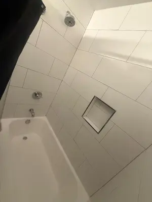 a bathroom with a bath tub with a window at Hollywood Prime Location Walk to Hollywood Attractions Free Parking in Los Angeles