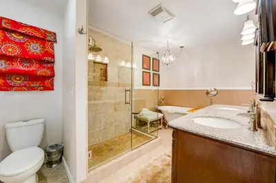 a bathroom with a toilet and a sink and a shower at Gregory Getaway in Crestline