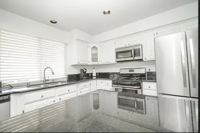 a kitchen with white cabinets and a stainless steel refrigerator at Valencia CA Stunning 3100 +sqft, 5Bed/5Bath home in Santa Clarita