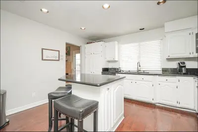 a kitchen with white cabinets and black counter tops at Valencia CA Stunning 3100 +sqft, 5Bed/5Bath home in Santa Clarita