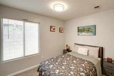 a bedroom with a bed and a window at Private Pool and Patio Pet-Friendly Bakersfield Gem in Bakersfield