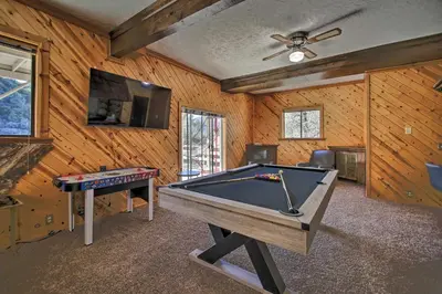 a living room with a pool table and a tv at Luxe Escape with Decks, Mtn Views, Game Room! in Frazier Park
