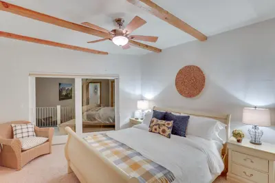 a bedroom with a bed and a ceiling fan at Beautiful Lake Arrowhead Cabin with EV Charger in Lake Arrowhead