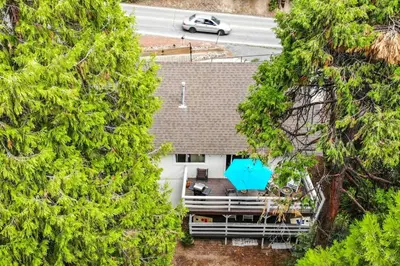 an overhead view of a house between two trees at Lake house Cabin - Lake Arrowhead in Lake Arrowhead
