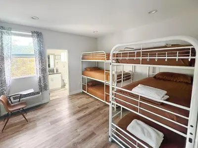 a room with two bunk beds and a desk at Fruit Hostel in Los Angeles