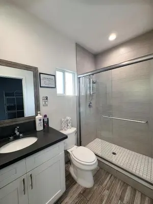 a bathroom with a shower and a toilet and a sink at Fruit Hostel in Los Angeles