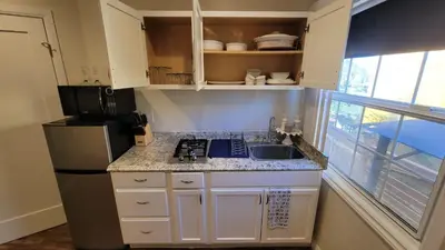 a small kitchen with a sink and a refrigerator at Adorable modern guesthouse with full kitchen in Encino