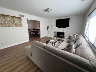 a living room with a couch and a fireplace at Beautiful and Cozy 4-BR residential home!!! in Oxnard