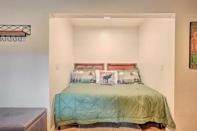 a bedroom with a bed with green sheets and pillows at Woodsy Twin Peaks Getaway with Hot Tub and Views! in Twin Peaks