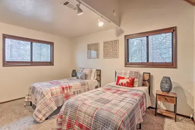 two beds in a room with two windows at Woodsy Twin Peaks Getaway with Hot Tub and Views! in Twin Peaks