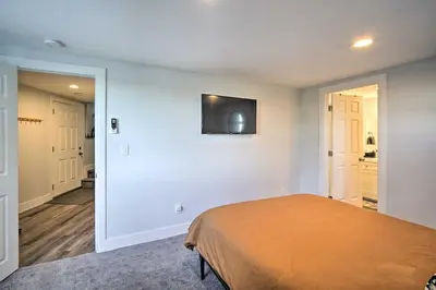 a bedroom with a bed and a flat screen tv on the wall at Chic Running Springs Forest Cabin with Deck! in Running Springs