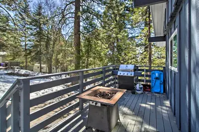 a picnic table on a deck with a grill at Chic Running Springs Forest Cabin with Deck! in Running Springs