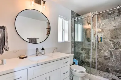 a bathroom with a sink and a shower at Stunning Lake Arrowhead Cabin with Lake Views! in Lake Arrowhead