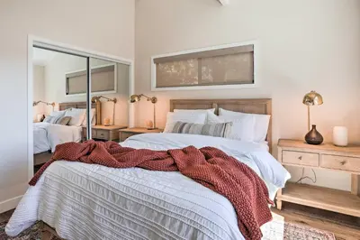 a bedroom with two beds and a large mirror at Stunning Lake Arrowhead Cabin with Lake Views! in Lake Arrowhead