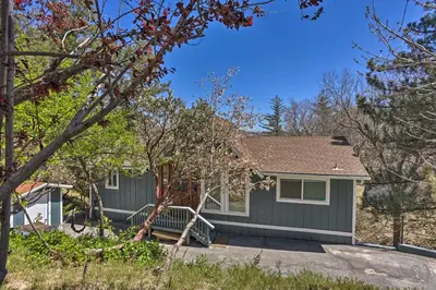 a home with a gray house with trees at Stunning Lake Arrowhead Cabin with Lake Views! in Lake Arrowhead
