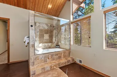 a large bathroom with a tub and a window at Stunning LAKE VIEW Game Room Spa Walk To Village in Lake Arrowhead